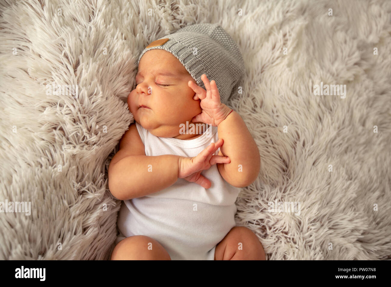 Baby boy kid newborn sleeping in hat on 