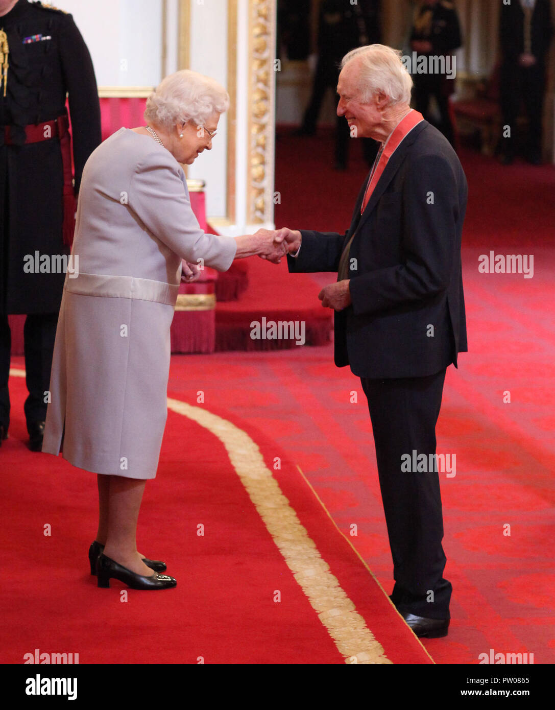 Mr. Bamber Gascoigne from Richmond is made a CBE (Commander of the Order of the British Empire) by Queen Elizabeth II, during an Investiture ceremony at Buckingham Palace, London. Stock Photo