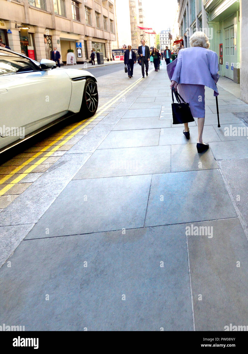 Old woman walking in Jermyn Street, London, England, UK. Stock Photo