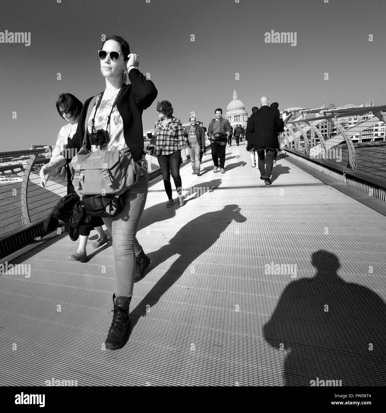 People crossing the Millennium Bridge, London, England, UK. Stock Photo