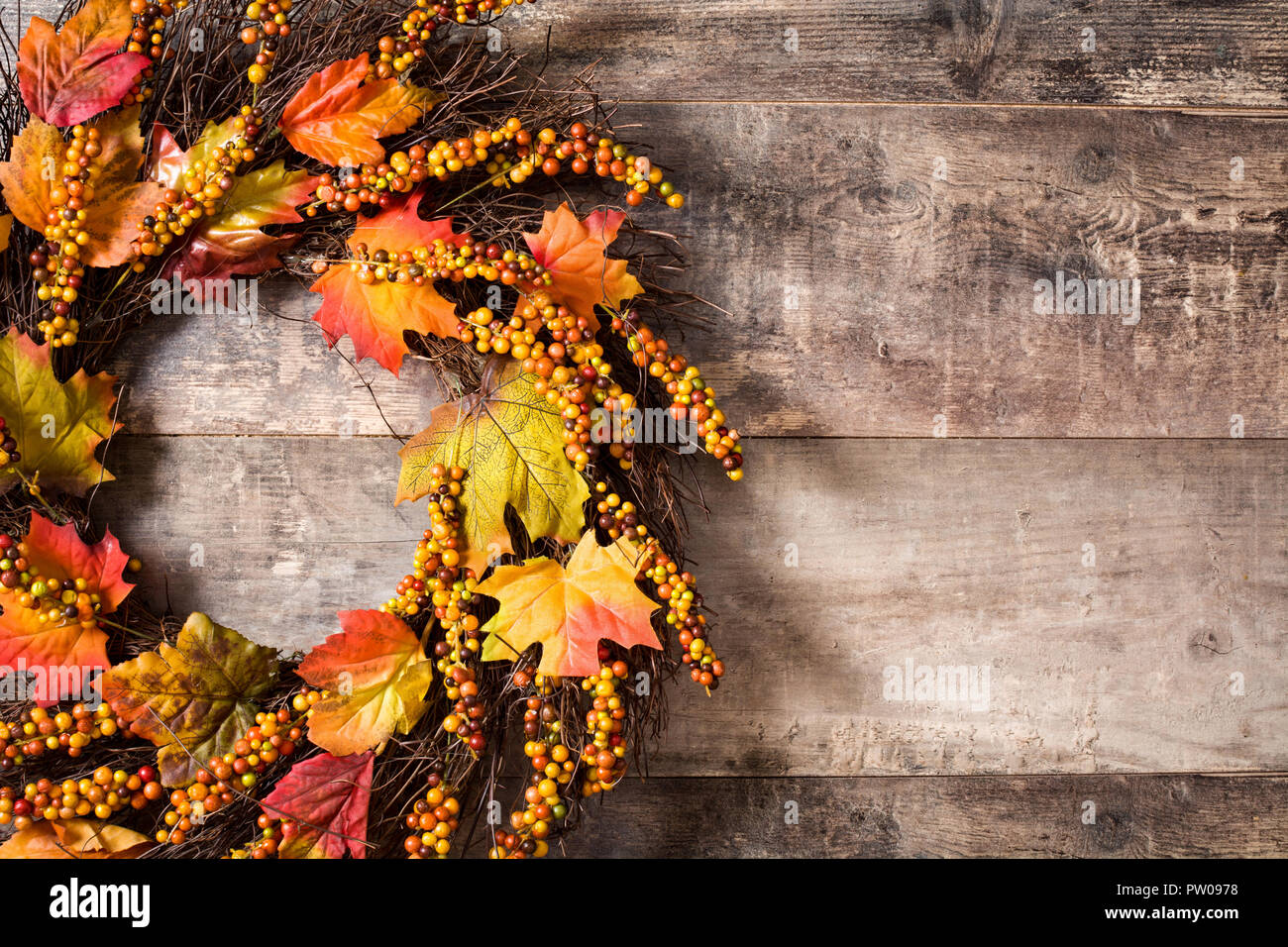 Autumn wreath on wooden background. Thanksgiving concept. Copyspace