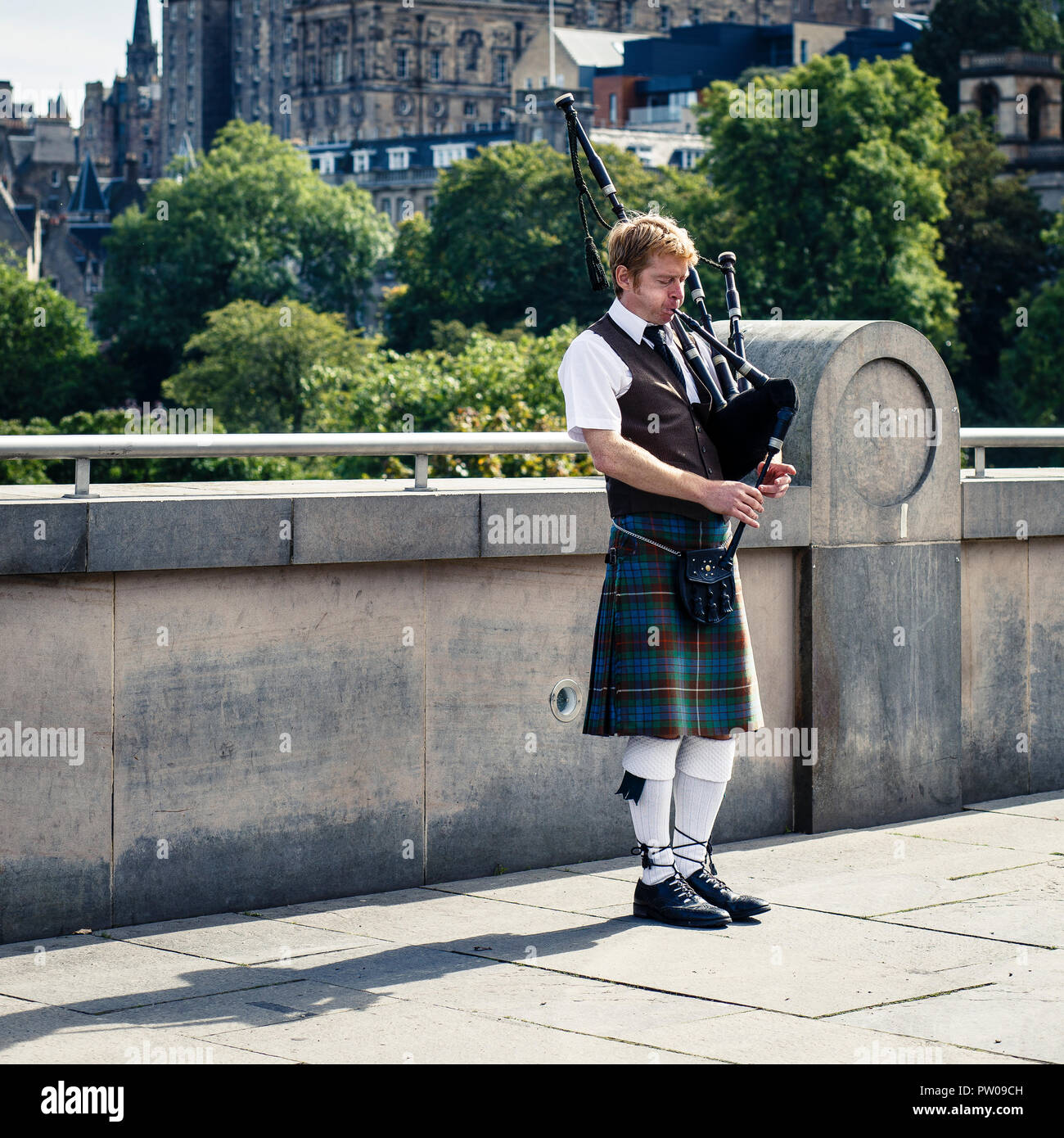Man playing on bagpipe in traditional Scottish kilt, Edinburgh, Scotland Stock Photo
