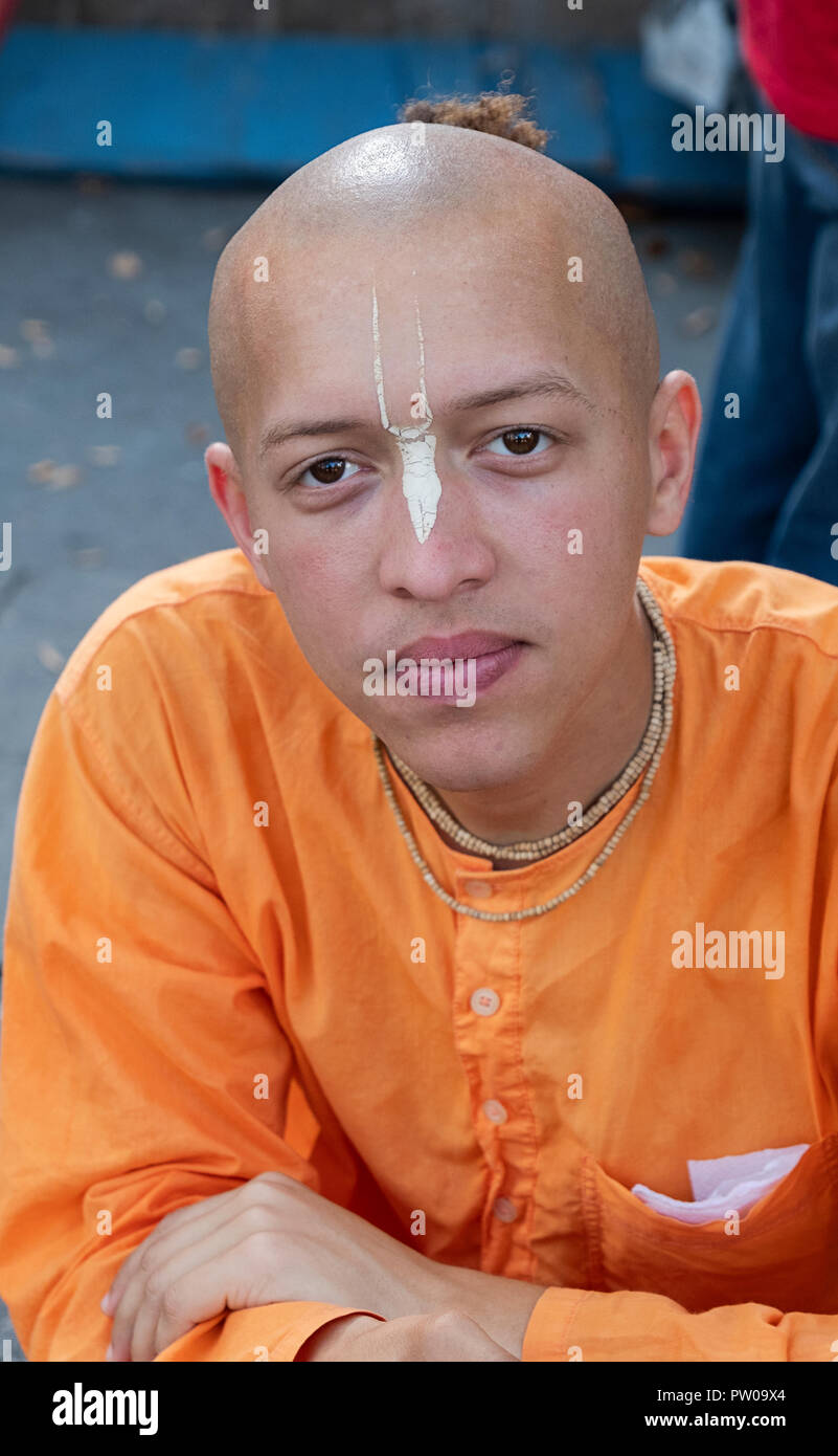 Head & shoulders photo of a Hari Krishna devotee with a TILAK marking on his forehead. In Union Square Park in Manhattan, New York City. Stock Photo