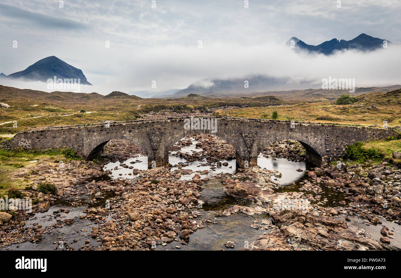 The old Sligachan bridge with Black Cuillin Mountains in background and low hanging clouds, Isle of Skye, Scotland Stock Photo