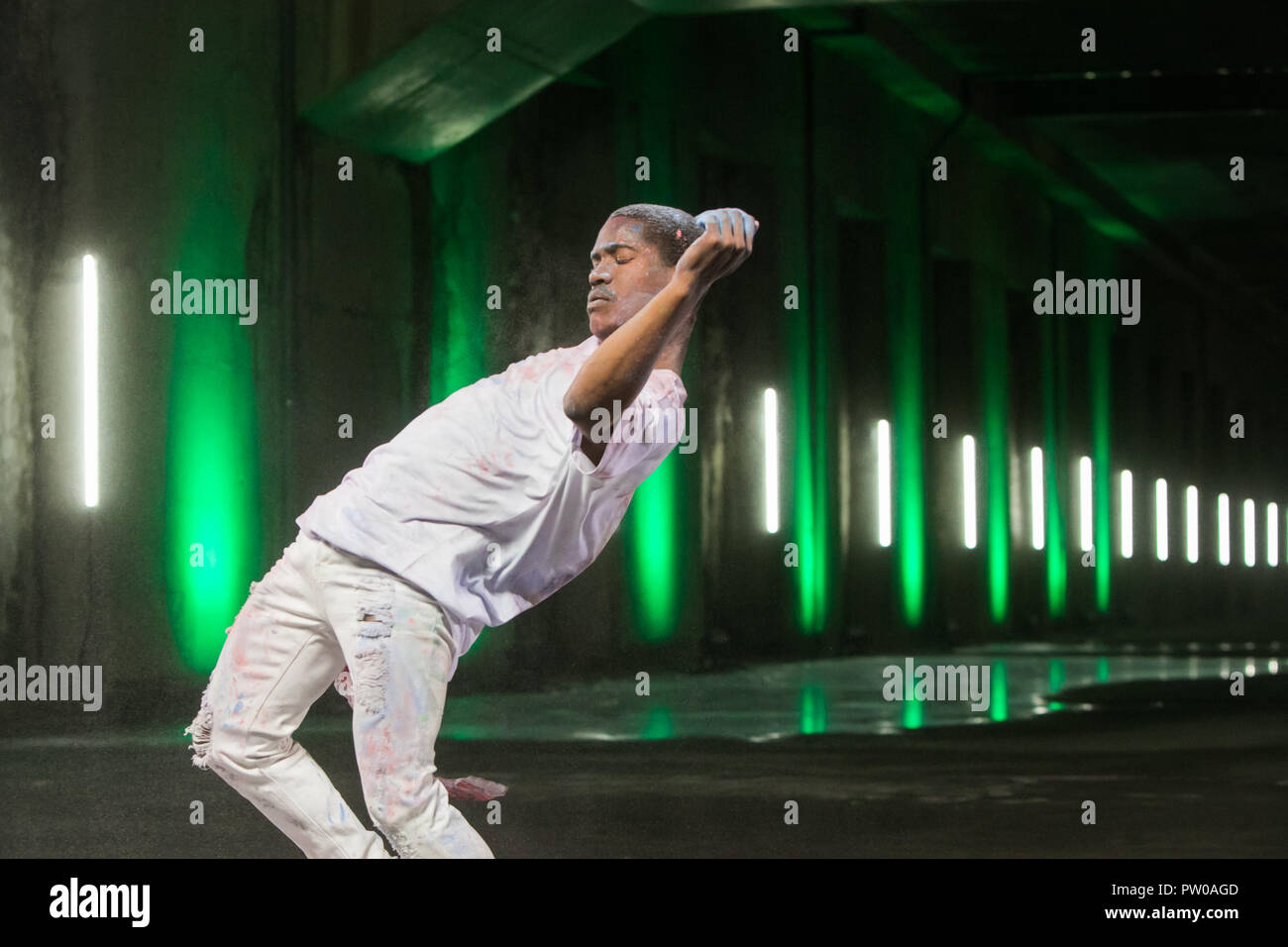 Man dancing with green background. Stock Photo