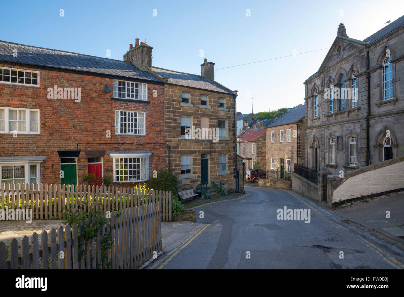 Street in the picturesque and historic village of Staithes on the coast of North Yorkshire, England. Captain Cook museum on the right. Stock Photo