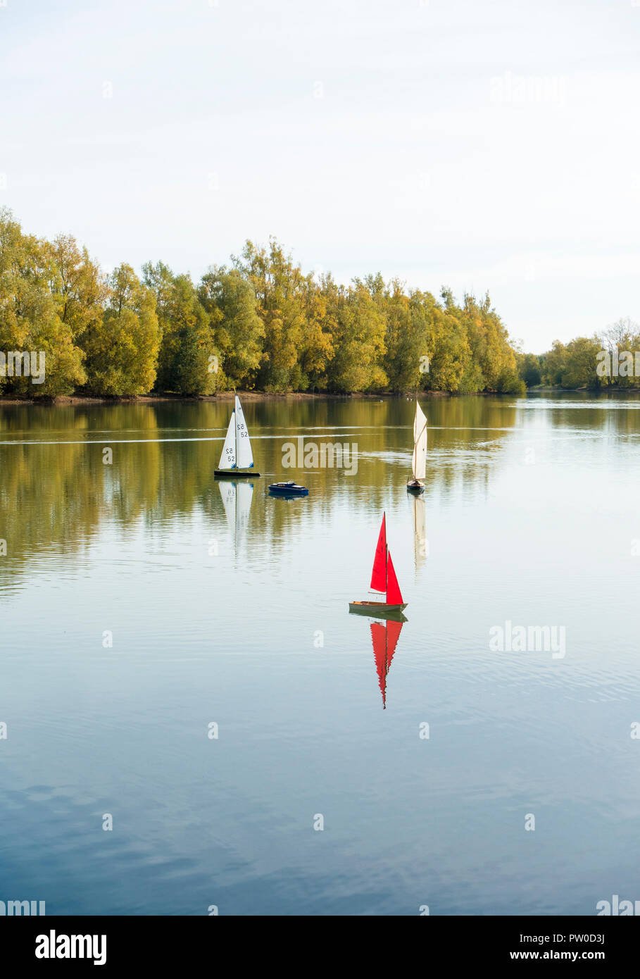 Three model sail boats on lake Stock Photo