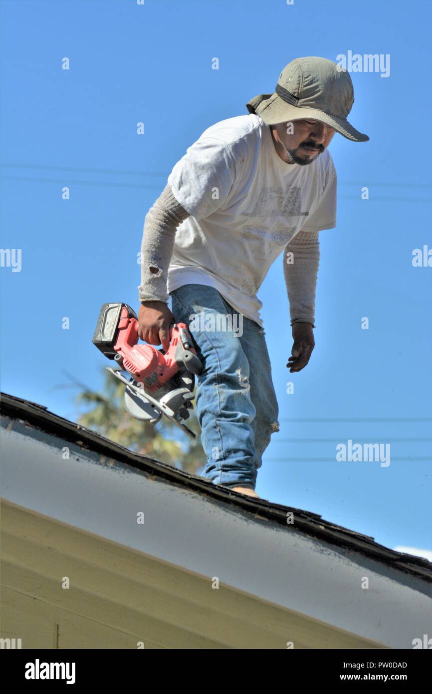 Latin labor knocking down a home for addition upstairs Stock Photo