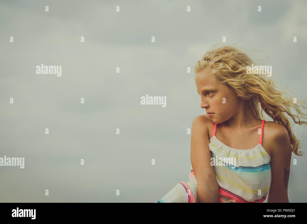 adorable little girl with blond hair portrait and blue sky Stock Photo ...