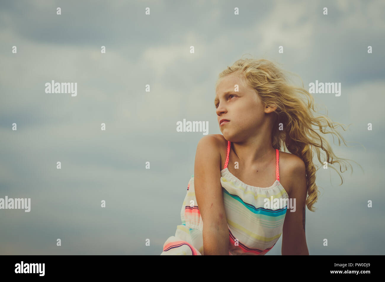 adorable little girl with blond hair portrait and blue sky Stock Photo ...
