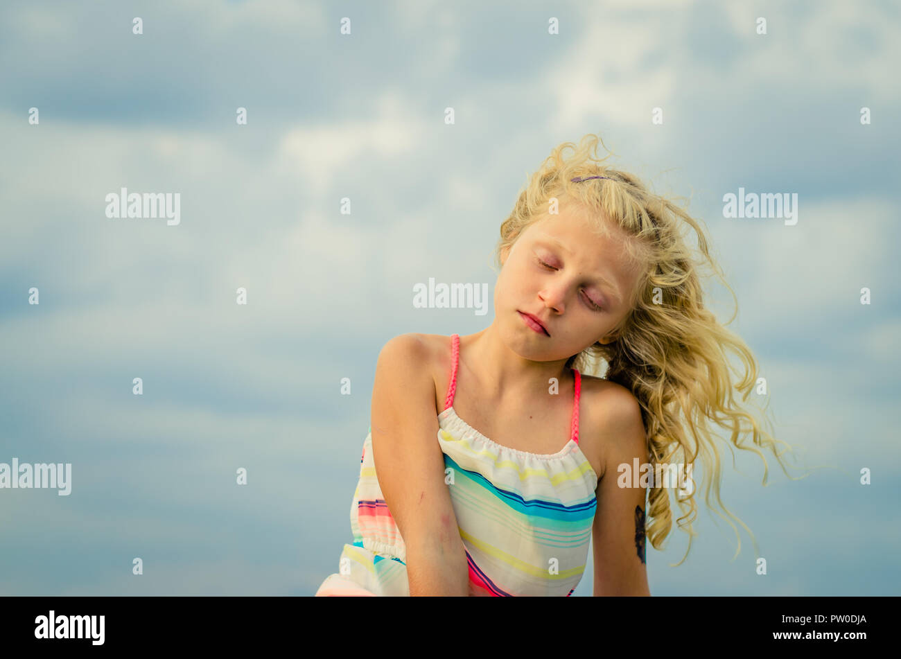 adorable little girl with blond hair portrait and blue sky Stock Photo ...