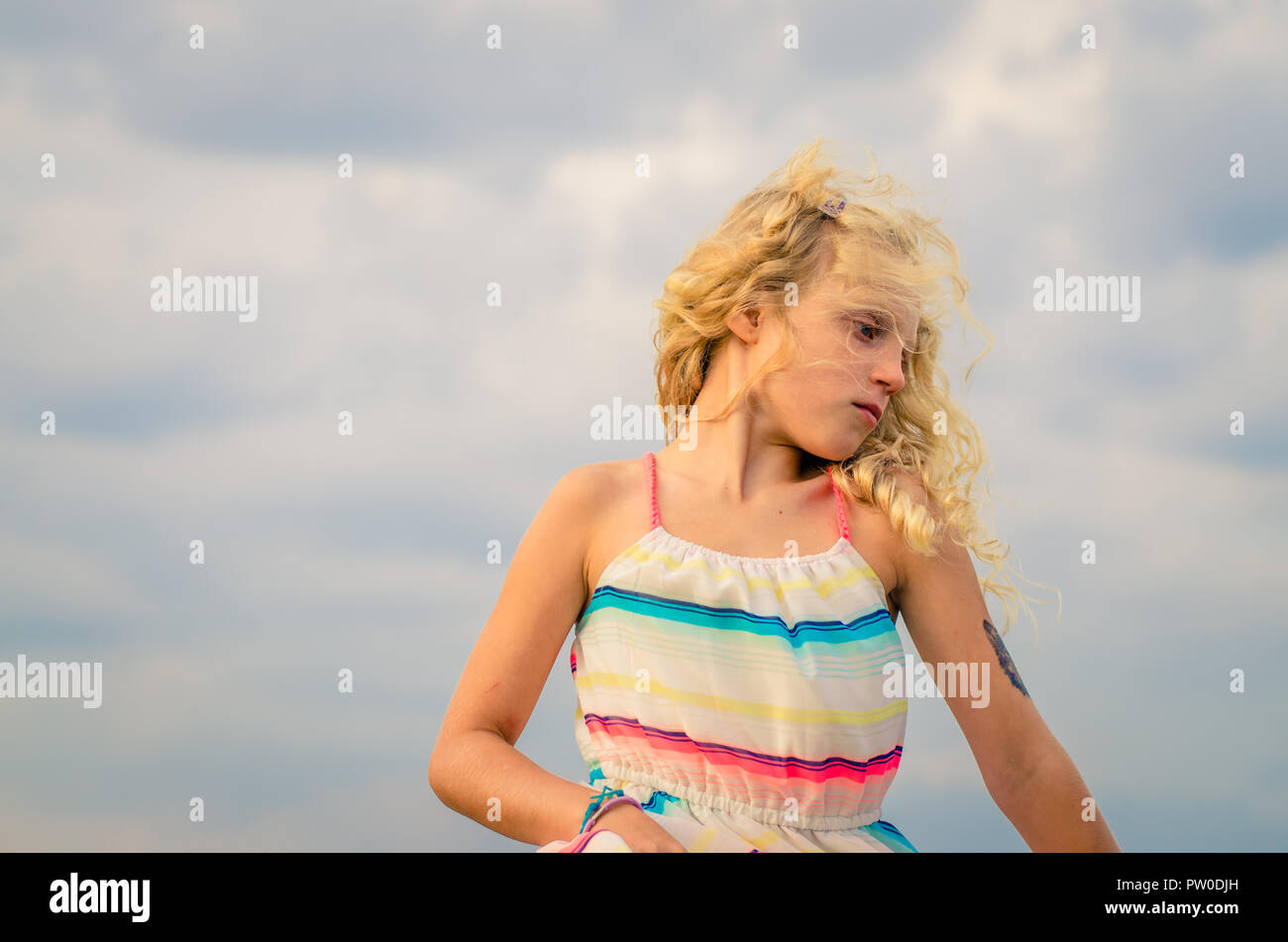 adorable little girl with blond hair portrait and blue sky Stock Photo ...