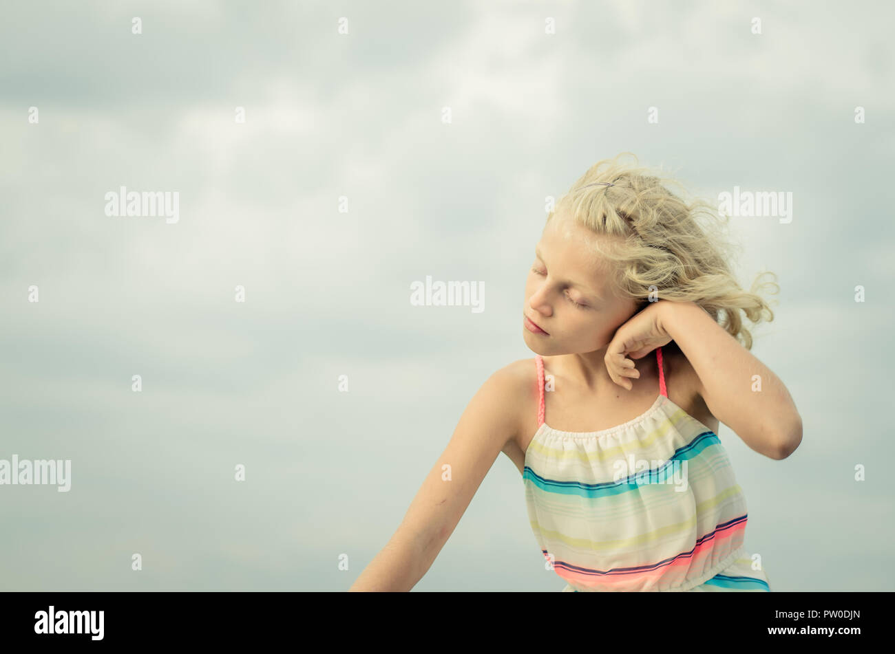 adorable little girl with blond hair portrait and blue sky Stock Photo ...