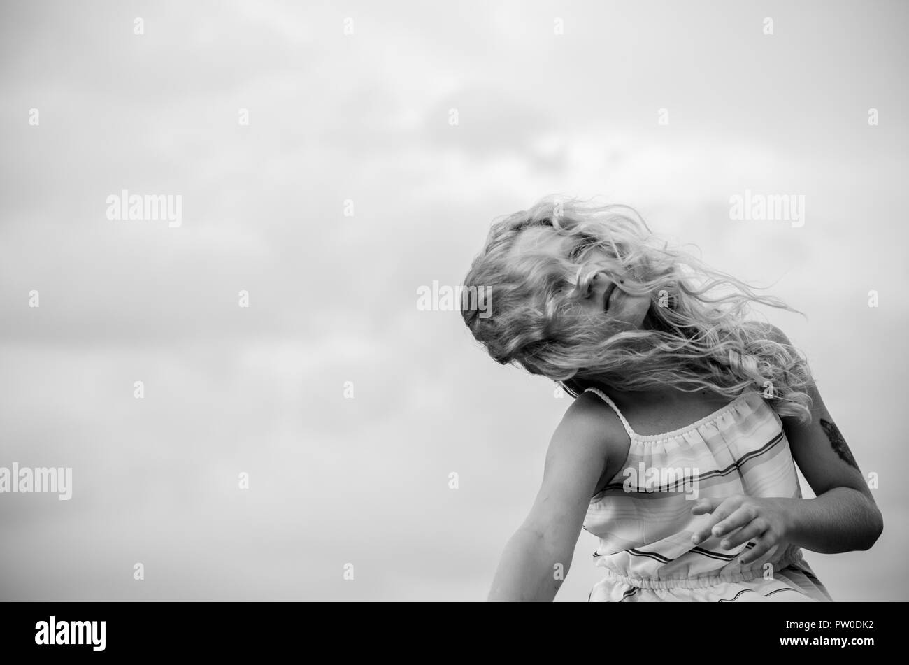 adorable little girl with blond hair portrait and blue sky Stock Photo ...
