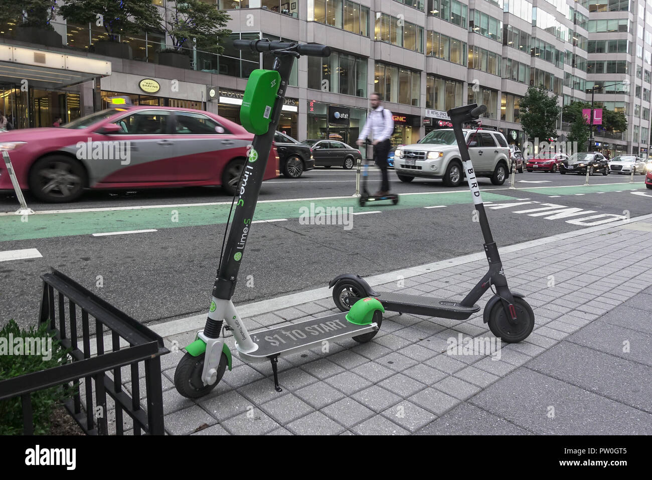 Skip Scooter rider in bikelane, 2 dockless electric scooters parked,  downtown, DC. Lime-S & Bird dockless scooters scooter companies operating  in DC Stock Photo - Alamy