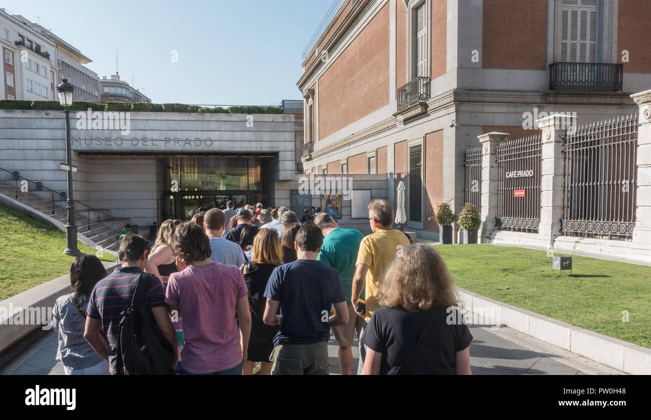 Tourists with timed tickets await entrance to popular Prado Museum in Madrid,  Spain. See Museo del Prado sign on building Stock Photo - Alamy