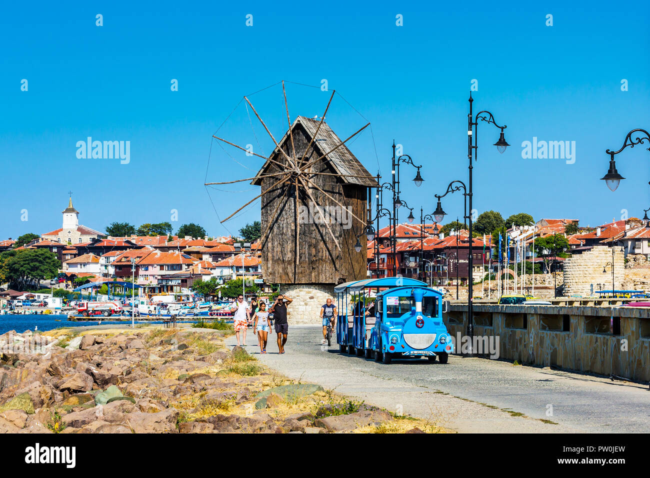 Nessebar, Bulgaria - July 25, 2016: Tourist train near old windmill in Nesebar in Bulgaria Stock Photo