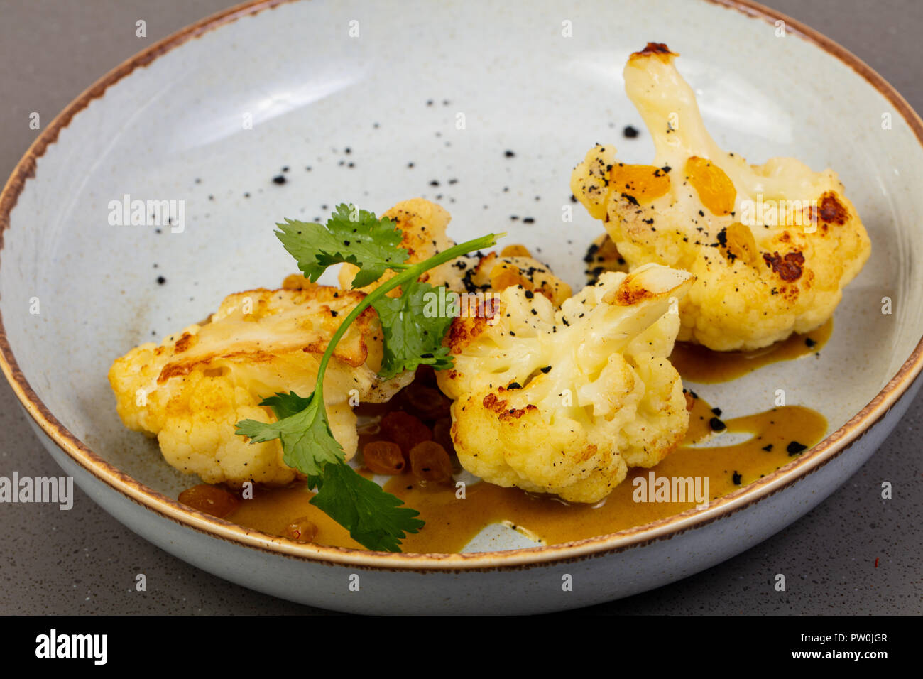 Roasted cauliflower with coriander leaves and sauce Stock Photo Alamy