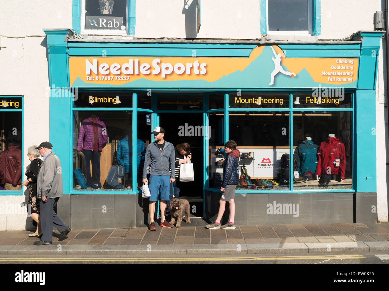 People outside Needle sports shop front in Keswick, Cumbria, England, UK Stock Photo