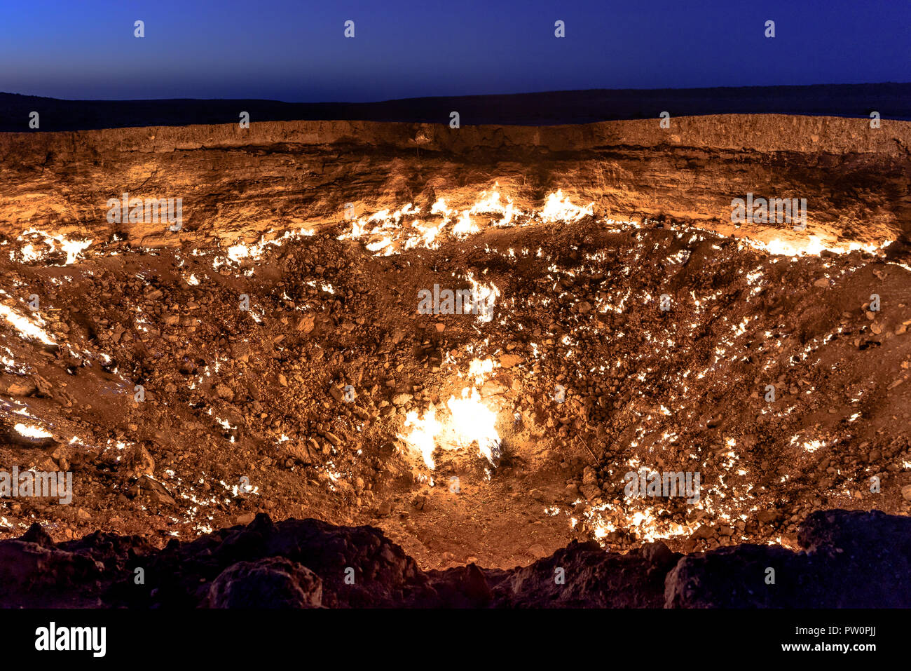 Turkmenistan gates of hell gas crater fire in Karakum desert near Darvaza. Burning methane gas crater in Derweze in Karakum desert. Door to hell Stock Photo