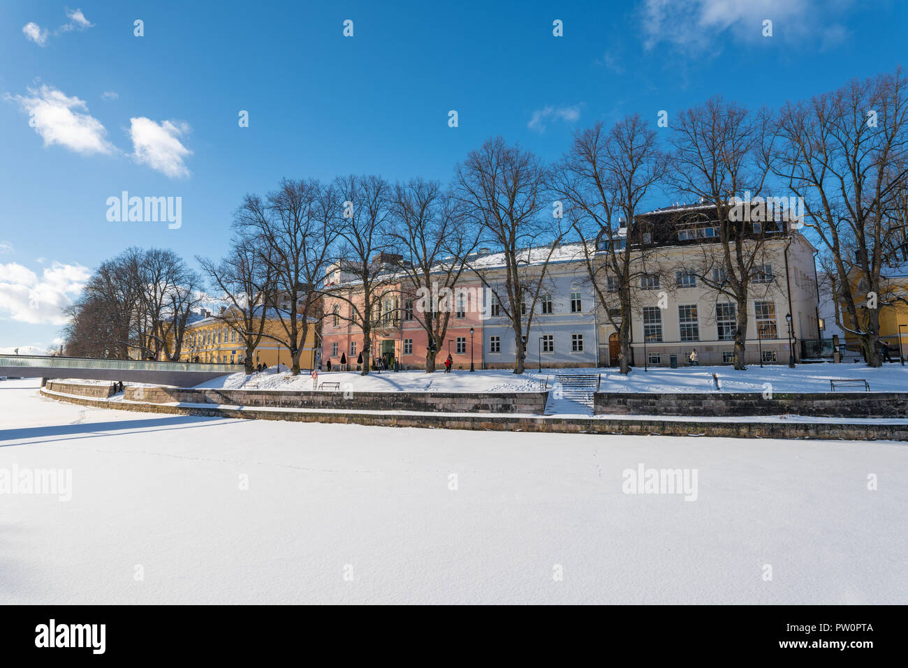 Colorful buildings by the shore of Aurajoki river at sunny winter day Stock Photo