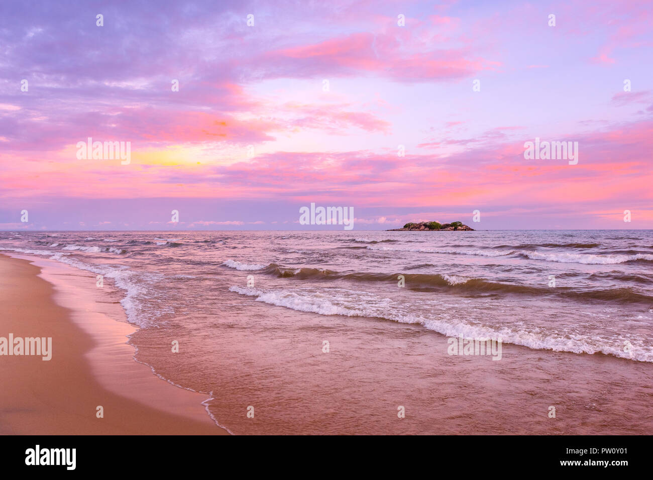 Pink sunset on lake beach sea sand beautiful colors in the sky clouds with island in the distance, Lake Malawi, Malawi, Africa Stock Photo