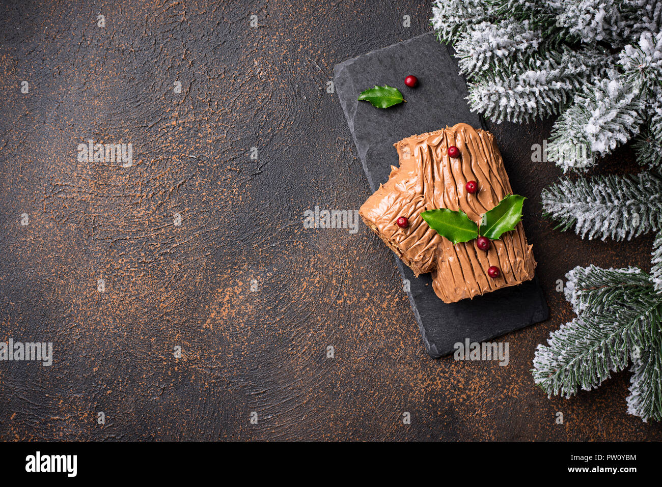 Christmas yule log cake. Traditional chocolate dessert on festive background Stock Photo