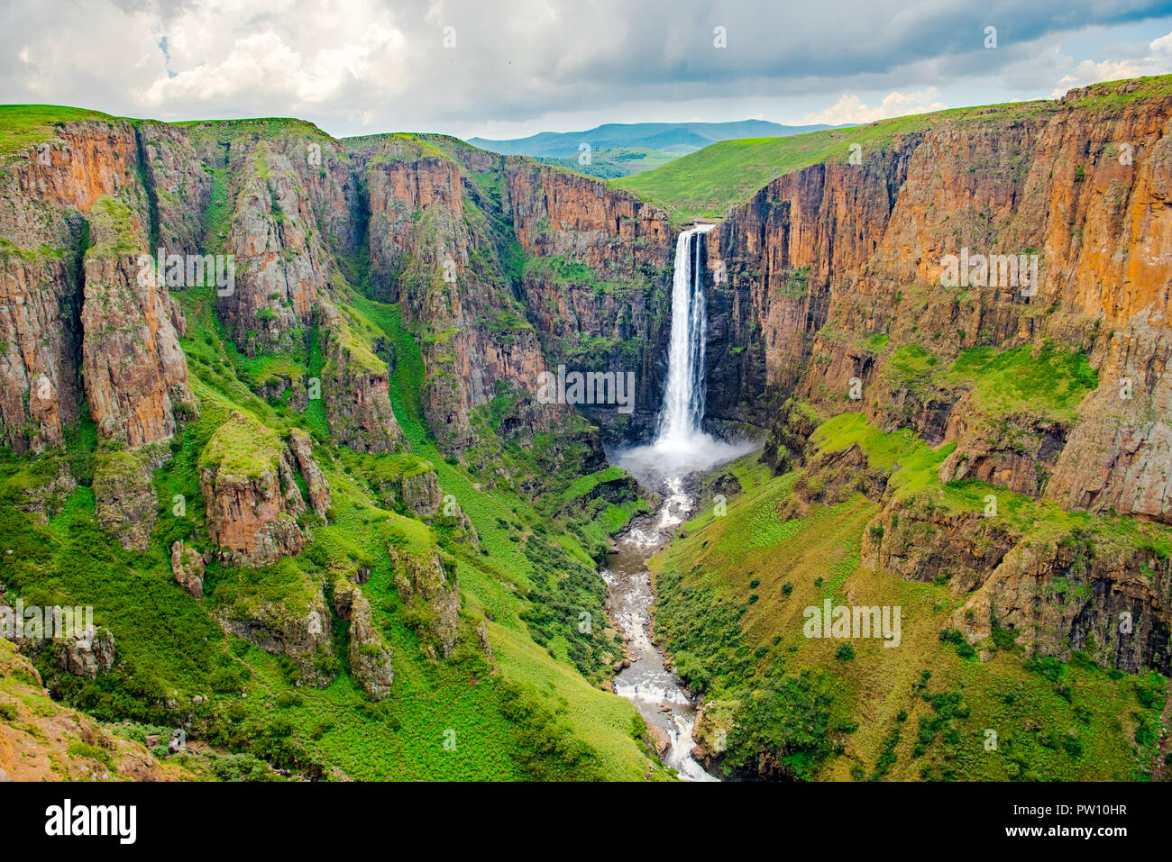 Maletsunyane Falls in Lesotho Africa. Most beautiful waterfall in the world. Green scenic landscape of amazing water fall dropping into a river inside Stock Photo