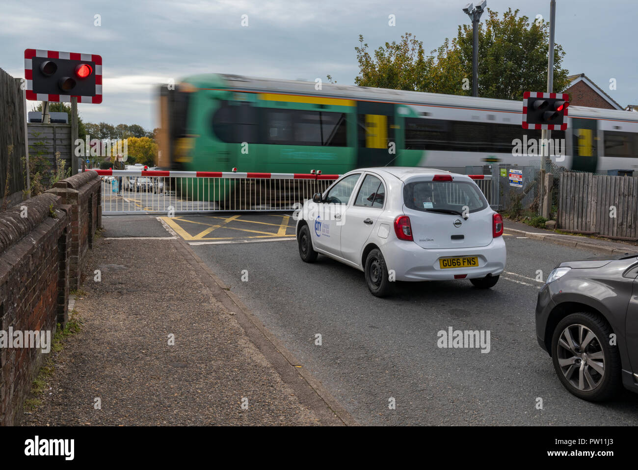 A Level Crossing With Full Barriers And Cctv With Flashing Red Lights And A Train Passing With Cars Waiting At The Gates To Cross The Railway Stock Photo Alamy A Level Crossing With Full Barriers And Cctv With Flashing Red Lights And A Train Passing With Cars Waiting At The Gates To Cross The Railway Stock Photo Alamy