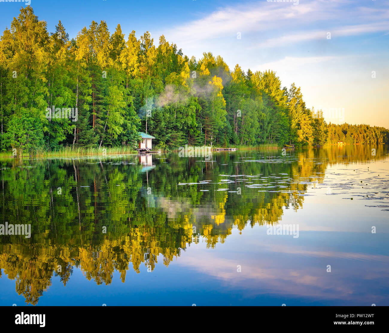 Lake in Tampere Finland, lake reflections on water with little house on the water, beautiful sky with many colors and trees Stock Photo