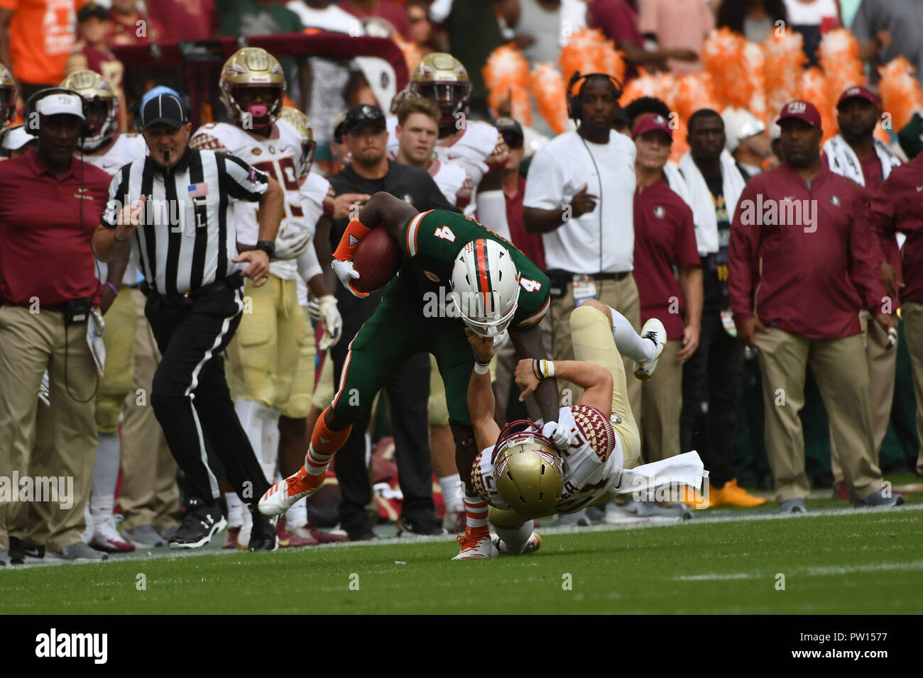 Miami Gardens, Florida, USA. 6th Oct, 2018. Jeff Thomas #4 of Miami is tackled by Logan Tyler #21 of Florida State during the NCAA football game between the Miami Hurricanes and the Florida State Seminoles in Miami Gardens, Florida. The Hurricanes defeated the Seminoles 28-27. Credit: csm/Alamy Live News Stock Photo