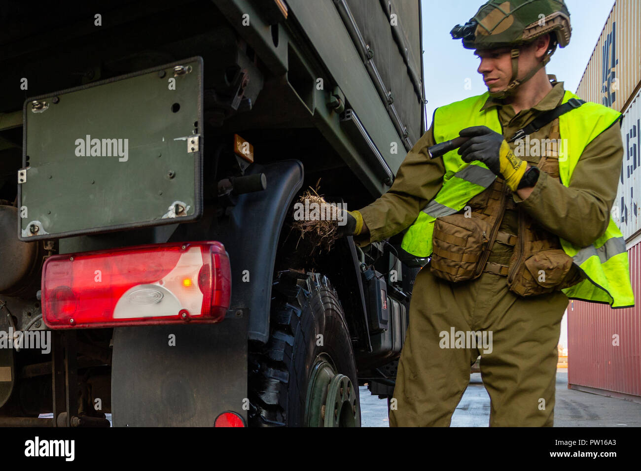 11 October 2018, Norway, Fredrikstad: A German Armed Forces vehicle is  examined by a Norwegian veterinarian in the course of the animal search  profileaxe after the shipment for the large manoeuvre of