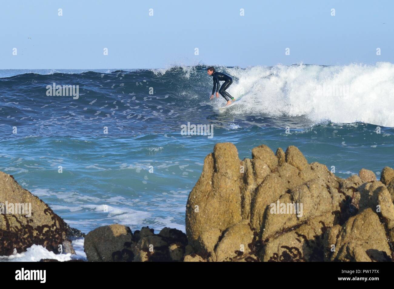 Pacific Grove, California, USA. 11th Oct, 2018. A dare devil surfer negotiates the rocks in the Pacific Ocean .at Point Pinos. Credit: Rory Merry/ZUMA Wire/Alamy Live News Stock Photo