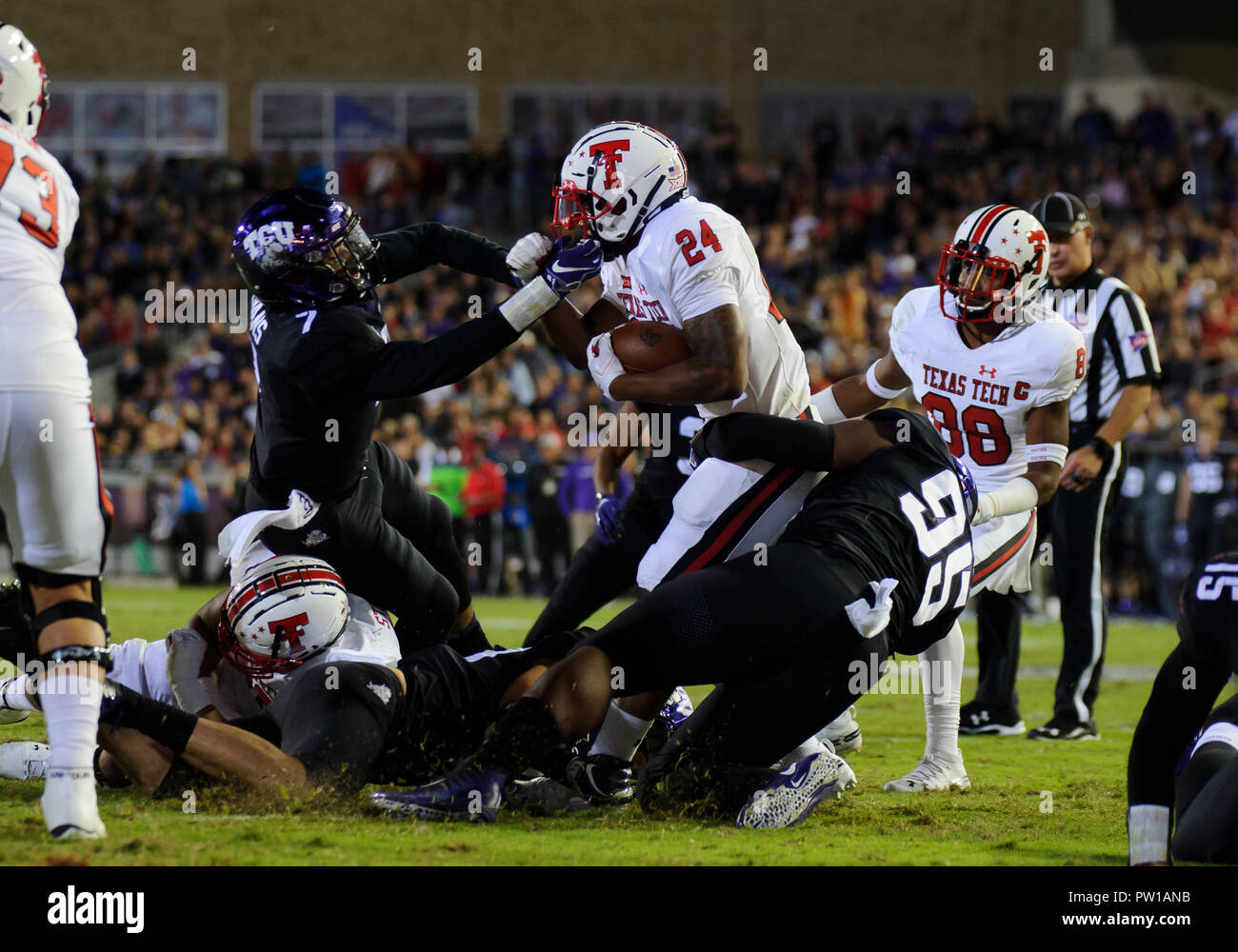 Waco, Texas, USA. 11th Oct, 2018. TCU Horned Frogs linebacker Arico Evans (7) and TCU Horned Frogs defensive end Dennis Collins (96) trying to tackle Texas Tech Red Raiders running back Tre King (24) during the 2nd half of the NCAA Football game between the Texas Tech Red Raiders Cyclones and the TCU Horned Frogs at Amon G. Carter in Waco, Texas. Matthew Lynch/CSM/Alamy Live News Stock Photo