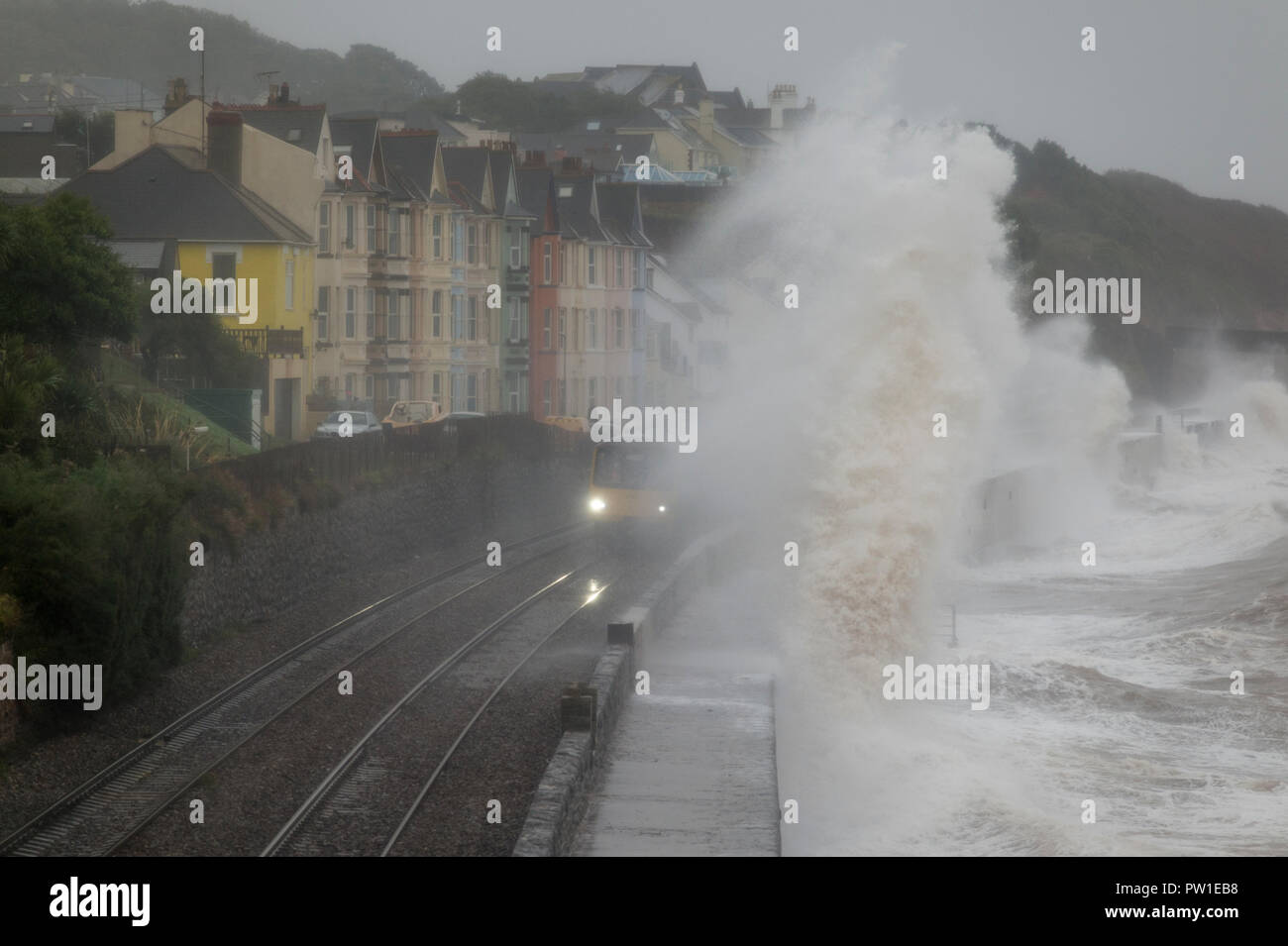 Dawlish, Devon, UK. 12th October, 2018. Storm Callum causes huge waves to crash across trains as they travel along the seafront at Dawlish, Devon, UK. Theo Moye/Alamy Credit: Theo Moye/Alamy Live News Stock Photo