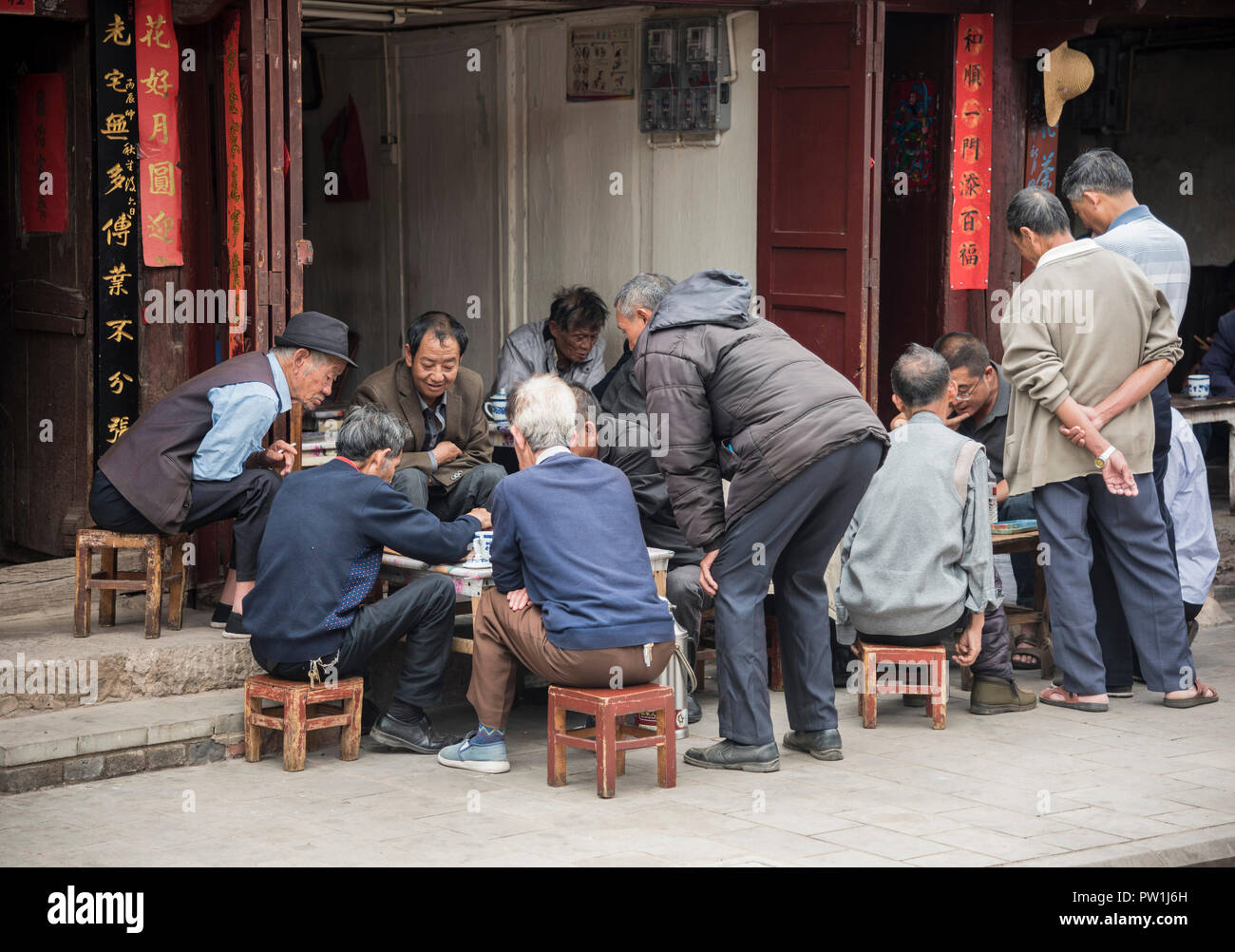 Chinese men playing board game in a street in Dali, Yunnan province  South West China. Stock Photo