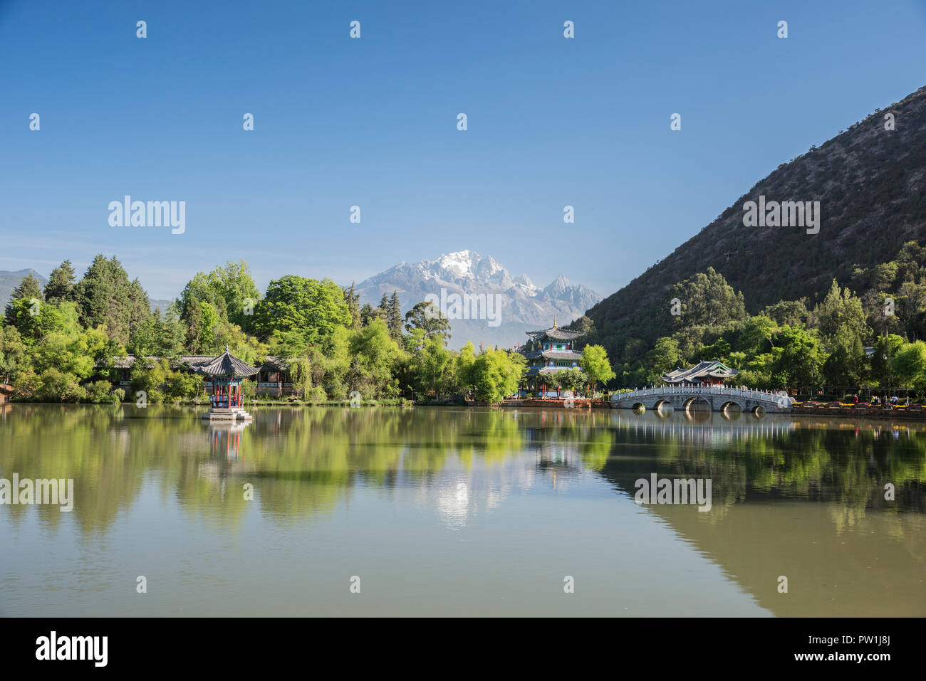 Looking across the Black Dragon Pool towards the Jade Dragon Snow Mountains of South West China Kunming. Stock Photo