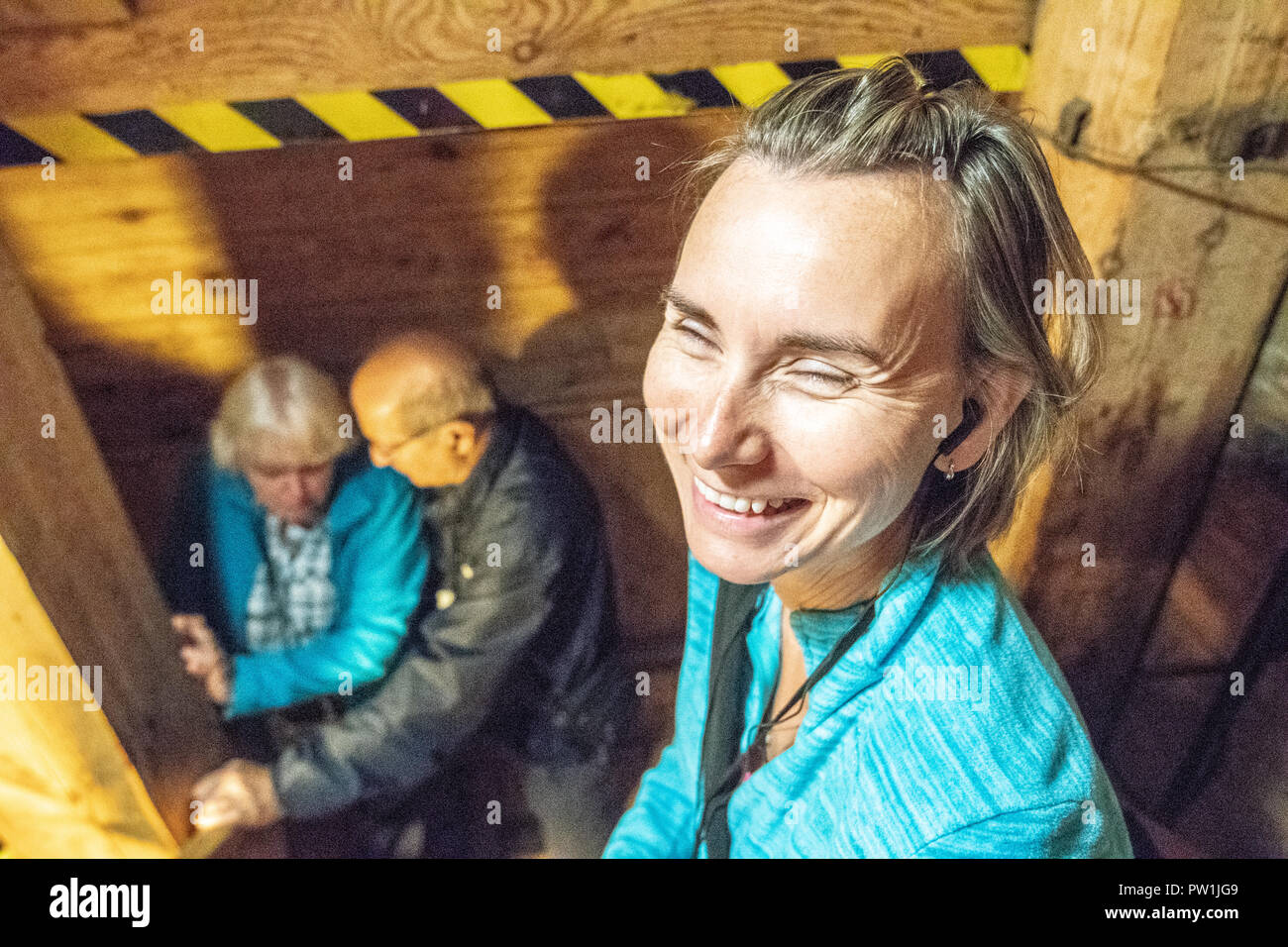 A woman smiles while touring the Wieliczka salt mine in Krakow Poland Stock Photo