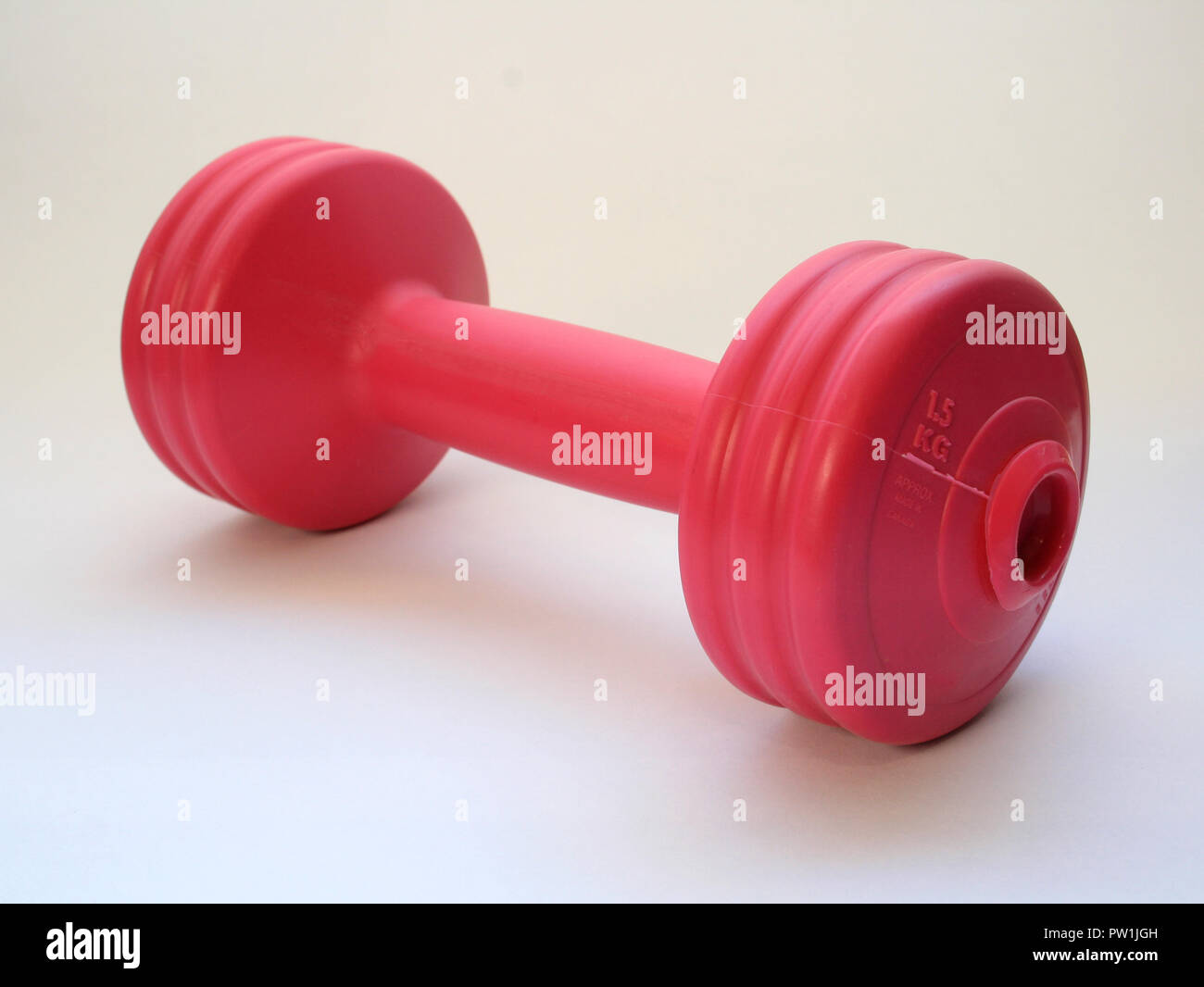 Pink 5KG Dumbbell isolated on a white background Stock Photo