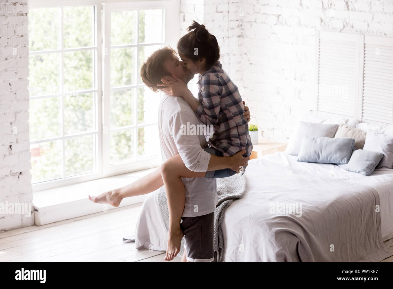 Young happy couple in love at home together Stock Photo