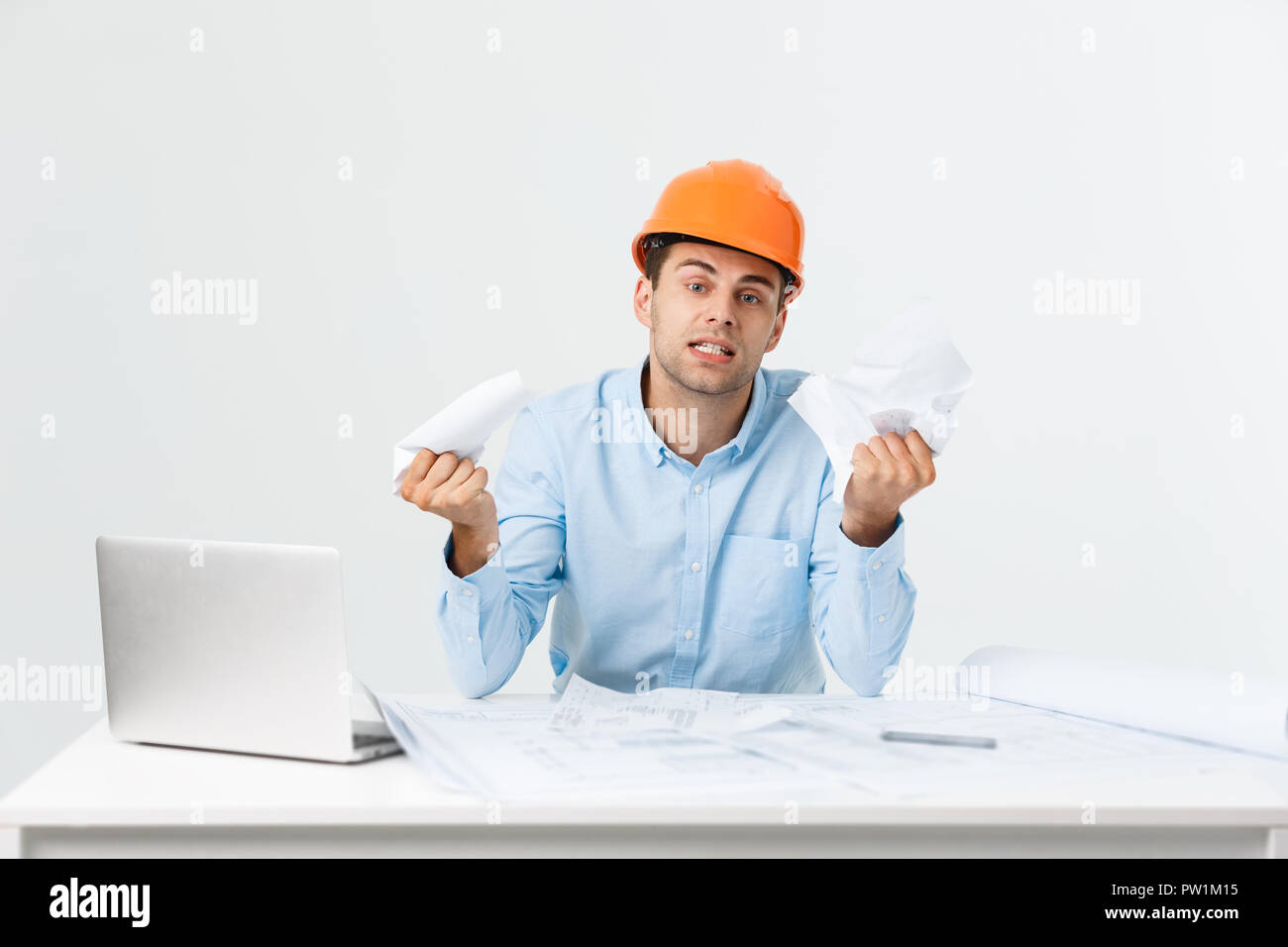 Crazy engineer or architect man with his project in his office. Angry