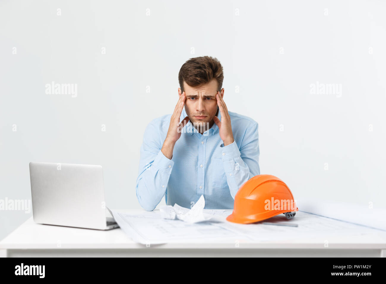 Crazy engineer or architect man with his project in his office. Angry