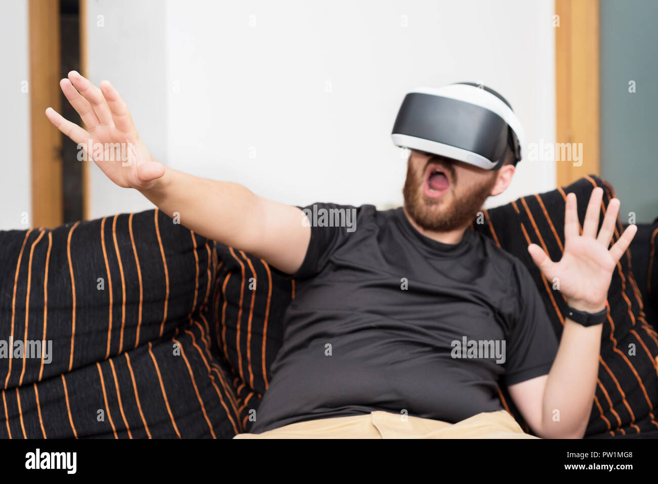 Bearded man wearing virtual reality goggles Stock Photo