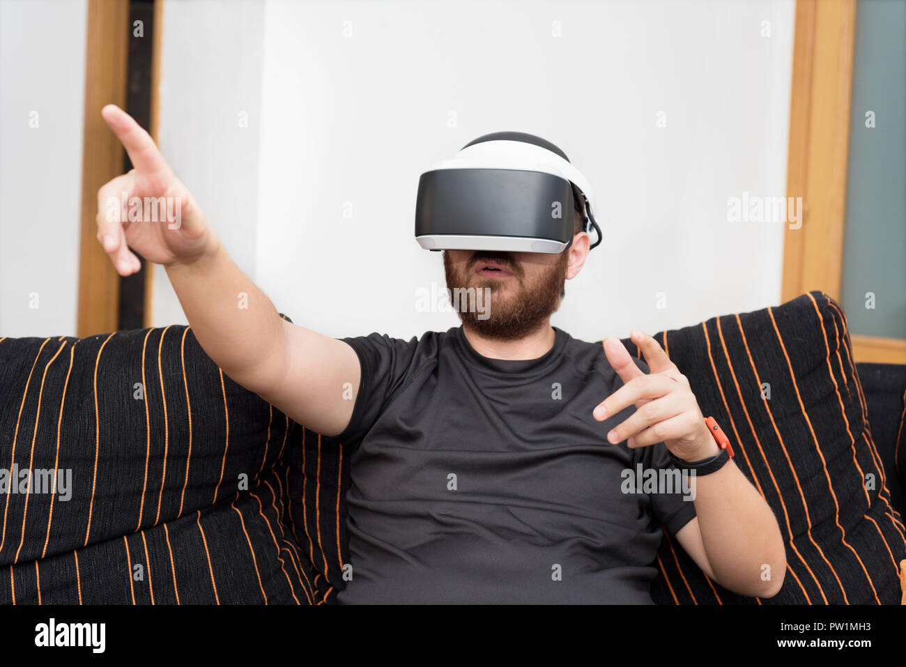 Bearded man wearing virtual reality goggles Stock Photo