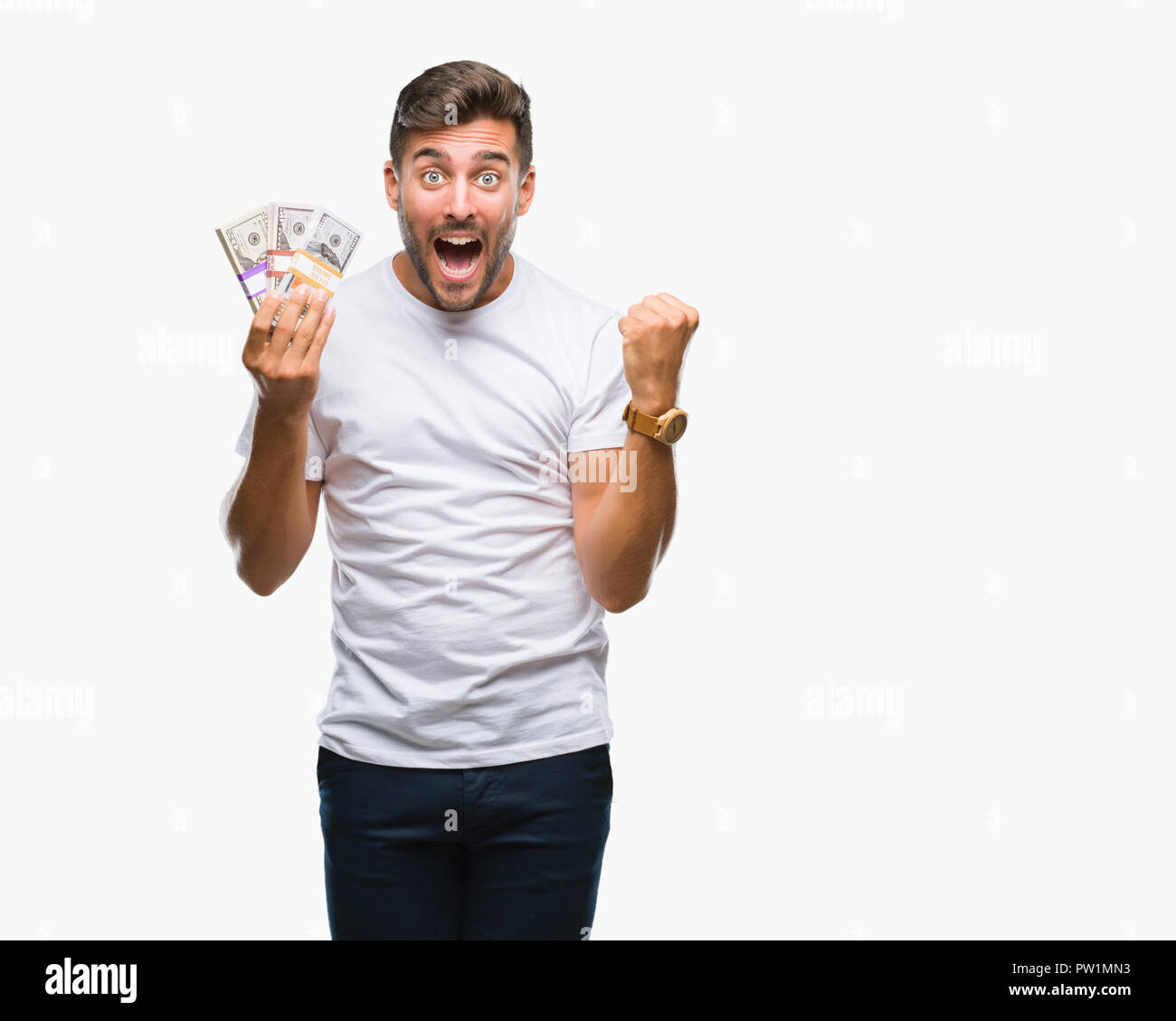 Young handsome man holding stack of dollars over isolated background ...