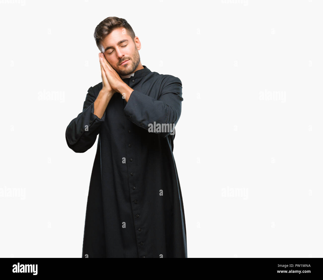 Young catholic christian priest man over isolated background sleeping