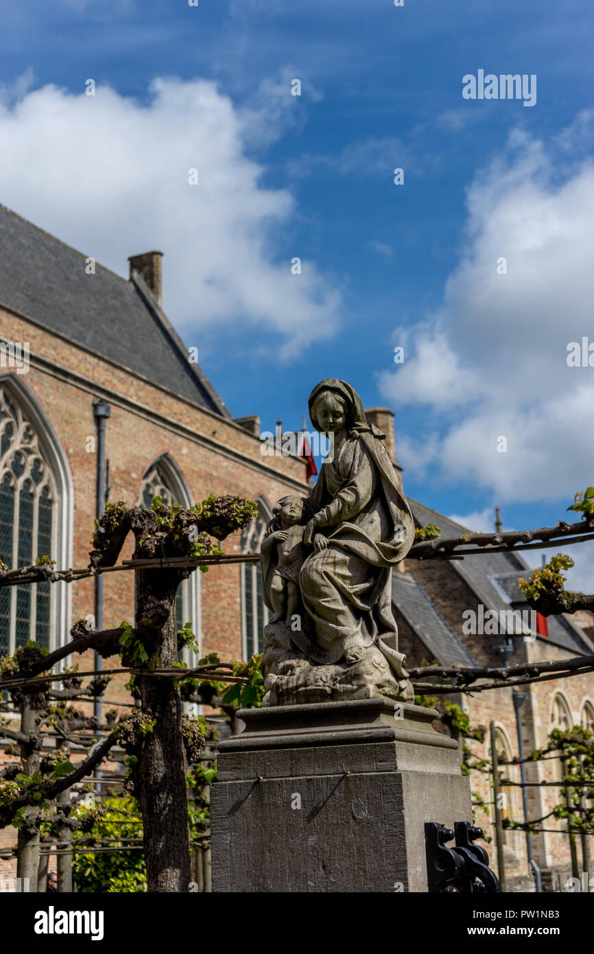 Statue of the lady and baby jesus christ at Brugge, Belgium, Europe on a bright summer day against a blue sky Stock Photo