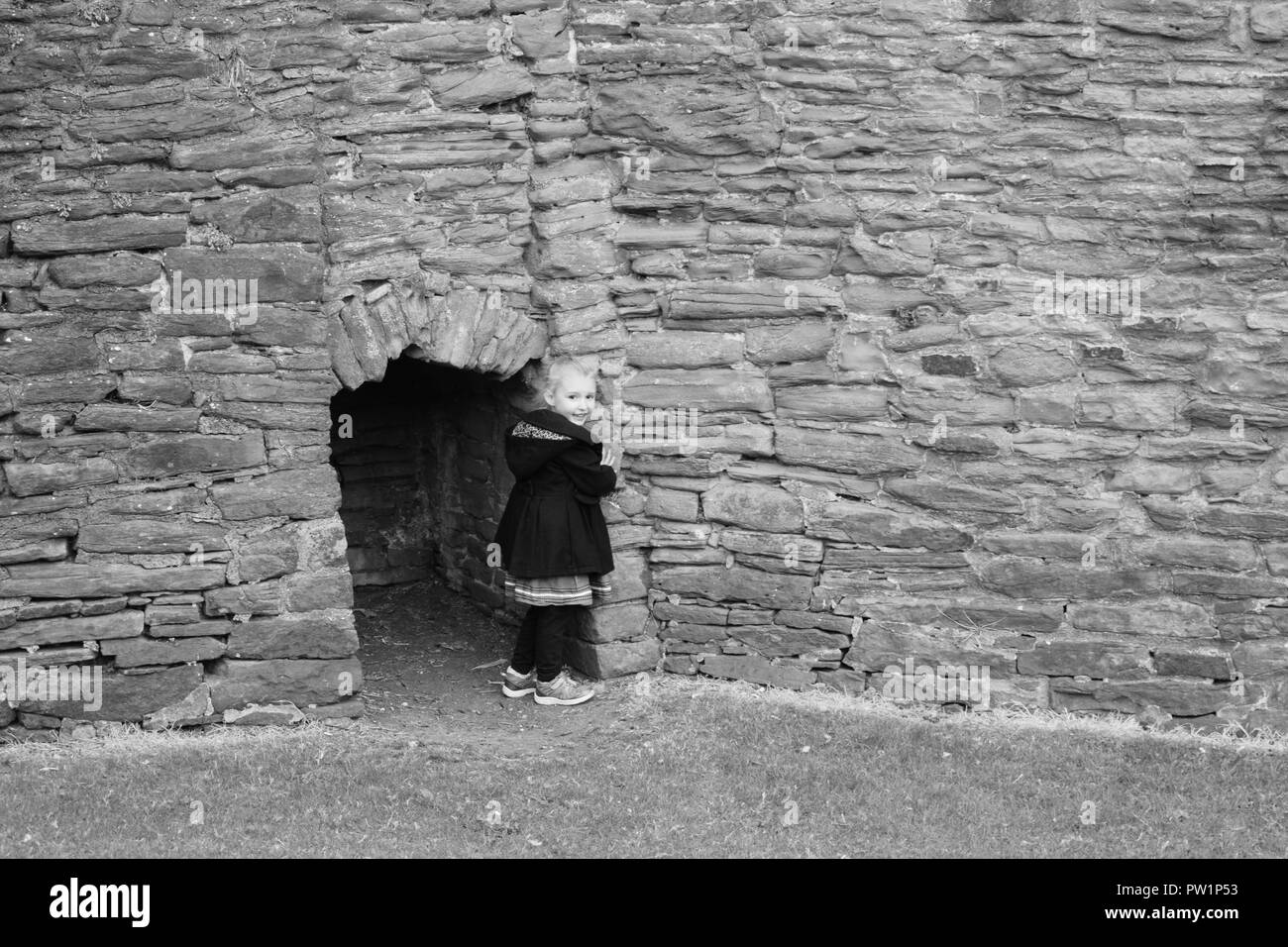 Child hiding in the castle walls Stock Photo