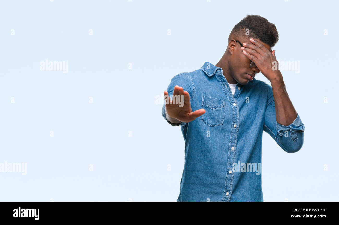 Young african american man over isolated background covering eyes with ...