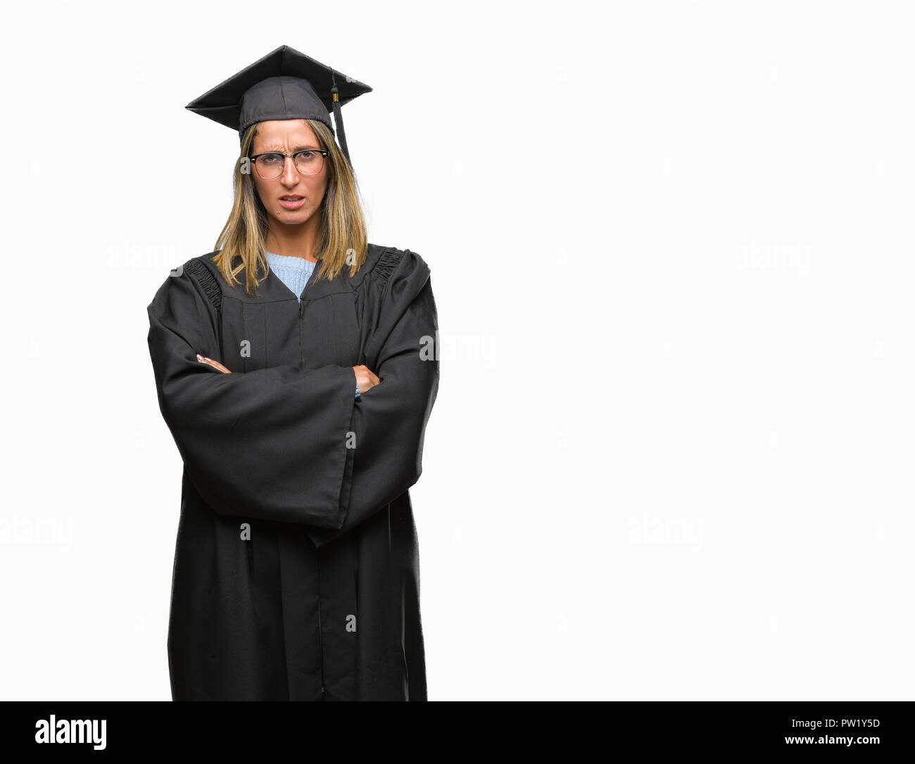 Young beautiful woman wearing graduated uniform over isolated background skeptic and nervous, disapproving expression on face with crossed arms. Negat Stock Photo